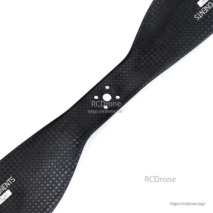 Matte carbon fiber drone propeller with visible weave finish and central mounting holes, MAD FLUXER Pro CCW