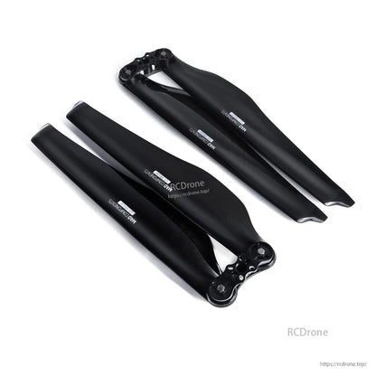 Black glossy carbon fiber folding drone propeller set with mounting hubs, two-blade assemblies