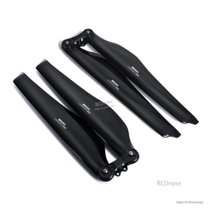 Pair of MAD FLUXER Pro carbon fiber folding propellers in black, with hinged hubs and wide blades