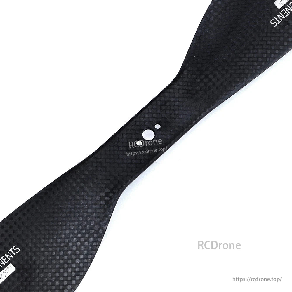 Matte carbon fiber drone propeller blade with woven finish and center mounting holes, RCDRONE branding