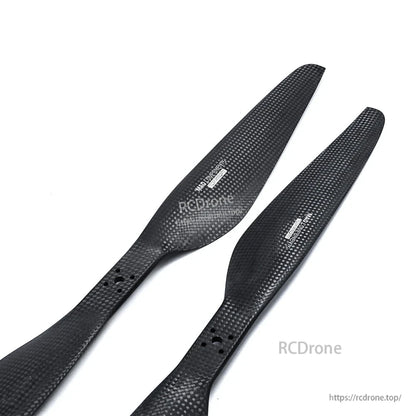 Pair of carbon fiber drone propellers with 10mm hub bore and mounting holes, black matte finish (CW/CCW)