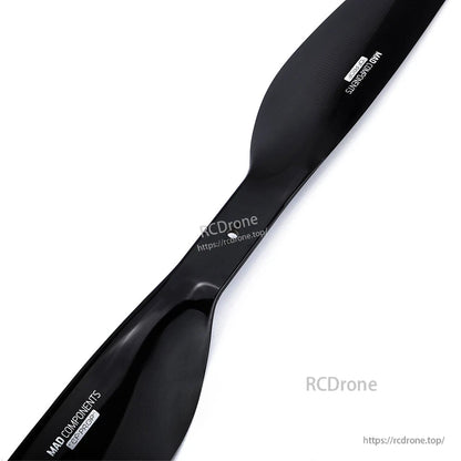 Glossy black carbon fiber drone propeller blade with MAD Components branding on a white background