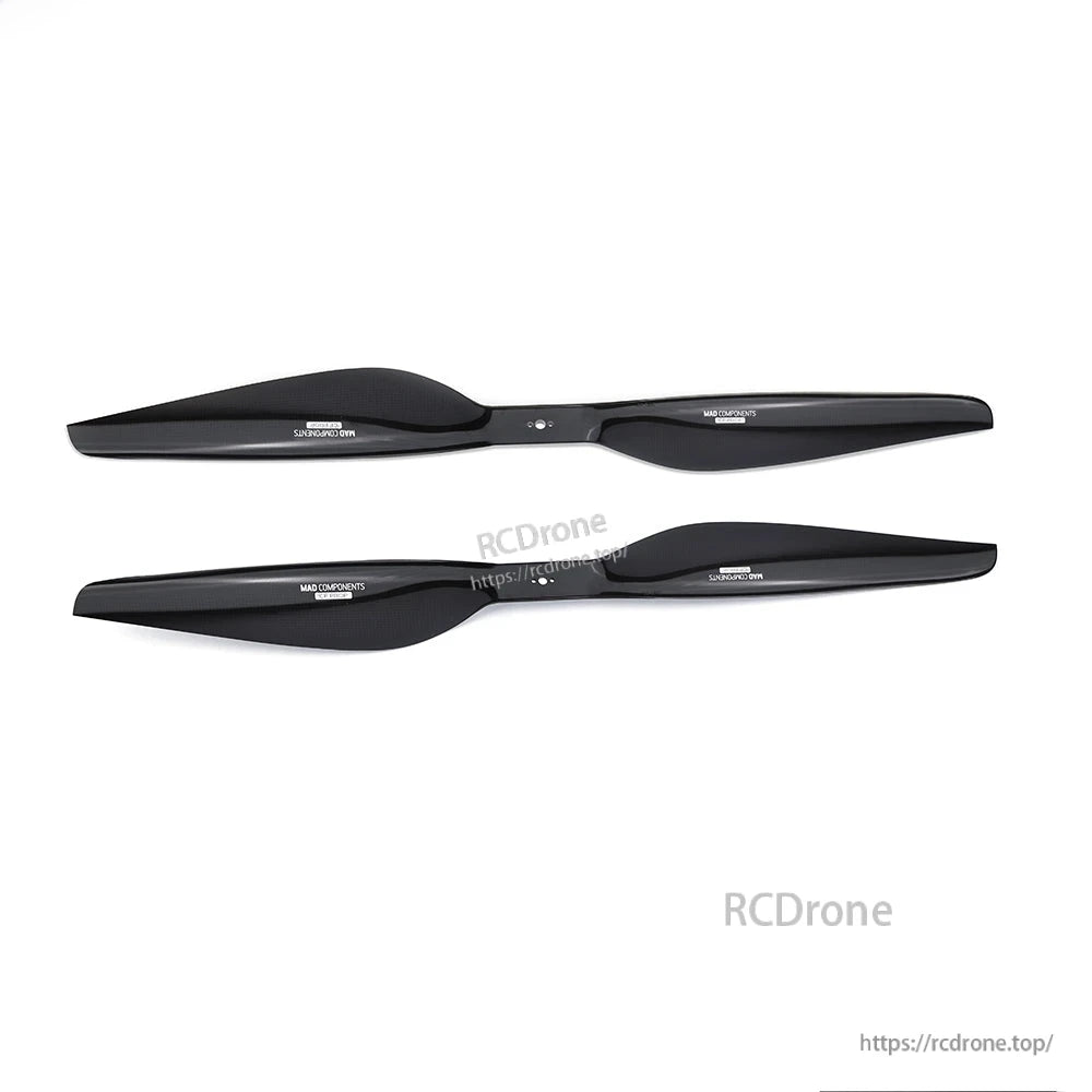 Pair of glossy black carbon fiber drone propeller blades from the MAD FLUXER Pro Shine kit