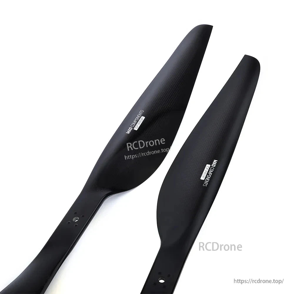 Pair of black MAD FLUXER Pro drone propeller blades with carbon-fiber style finish and mounting holes