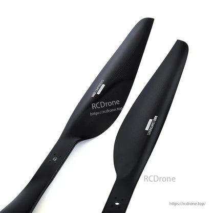 Pair of black MAD FLUXER Pro drone propeller blades with carbon-fiber style finish and mounting holes