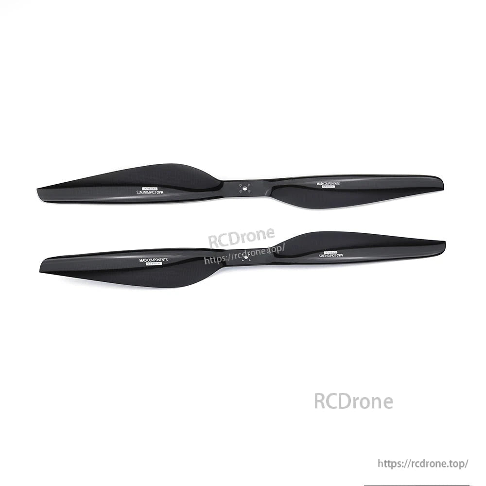 Pair of black two-blade carbon fiber propellers for RC aircraft, with center hub holes and printed markings