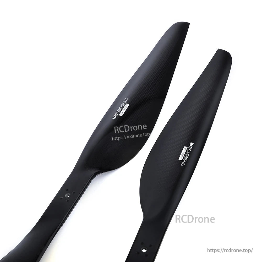 Pair of black carbon fiber drone propellers with mounting holes, one CW and one CCW blade