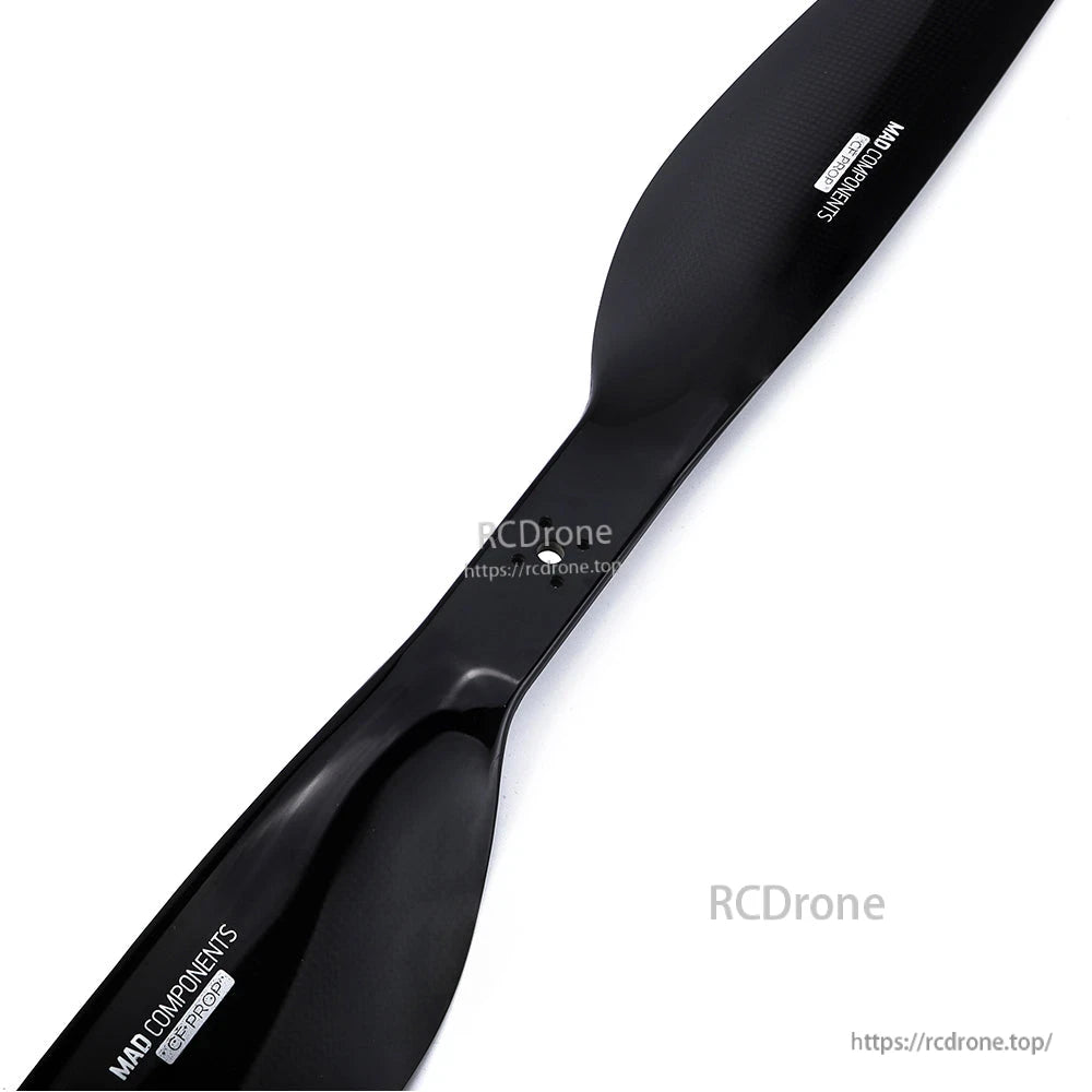 Black carbon fiber drone propeller with MAD Components branding and glossy finish