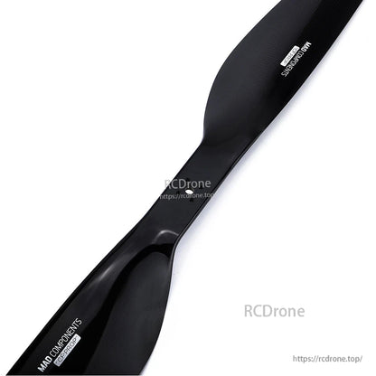 Black carbon fiber drone propeller with MAD Components branding and glossy finish