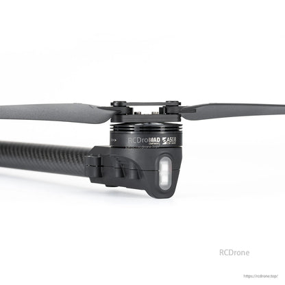 Close-up of MAD StableCore A510 drone arm with carbon fiber tube, motor mount, propeller and front LED.