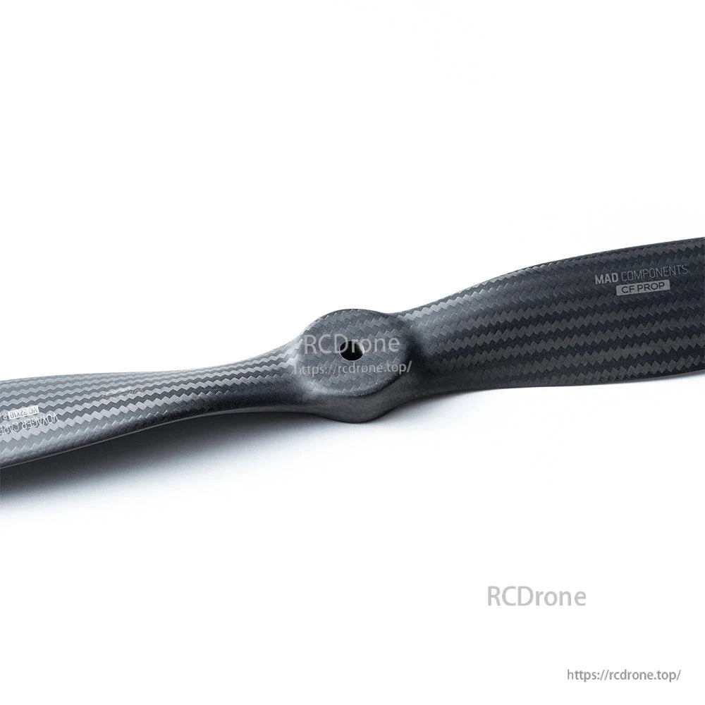 MAD VC 21x10-R IN Carbon Fiber Propeller, Close-up of a MAD Components carbon fiber propeller blade with visible weave pattern and logo text