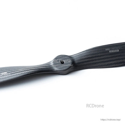 MAD VC 21x10-R IN Carbon Fiber Propeller, Close-up of a MAD Components carbon fiber propeller blade with visible weave pattern and logo text