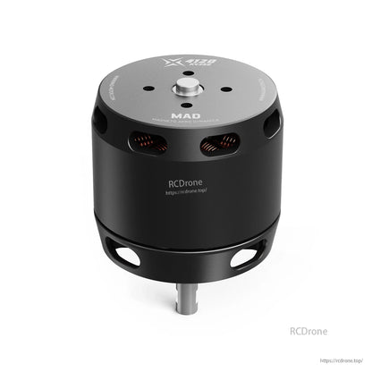MAD X4120 brushless drone motor with black cylindrical housing, vent slots showing copper windings, and center shaft