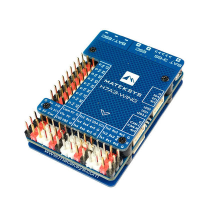Matek H7A3-WING flight controller board with labeled pin headers and blue MATEKSYS top plate