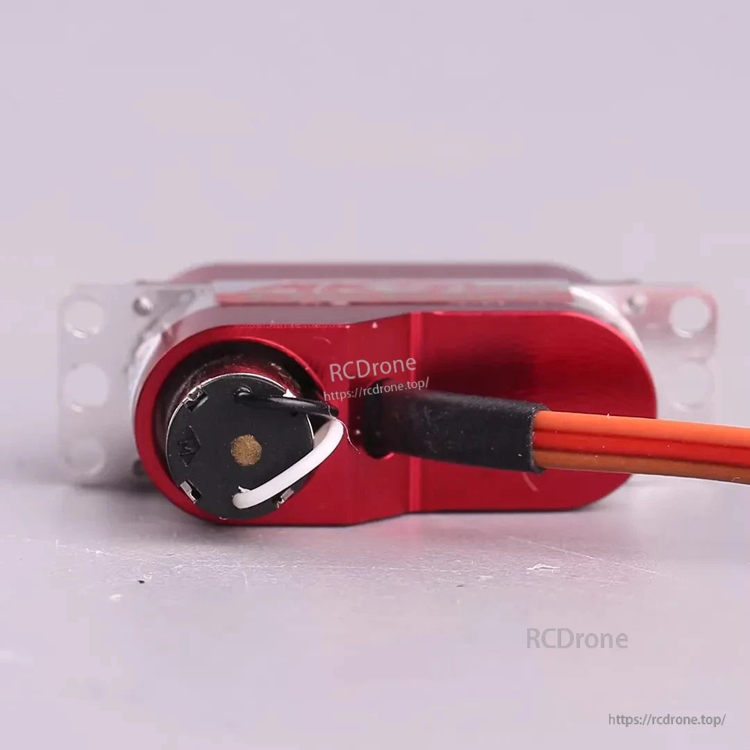 MKS DS65K Digital Servo, Red servo motor with orange wires and metal casing