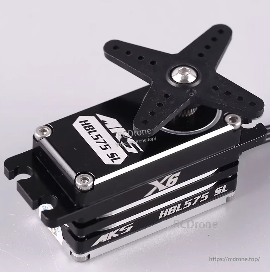 Compact MKS X6 HBL575SL brushless servo with titanium gears, star mount, silver screws, black casing, and white labeling.