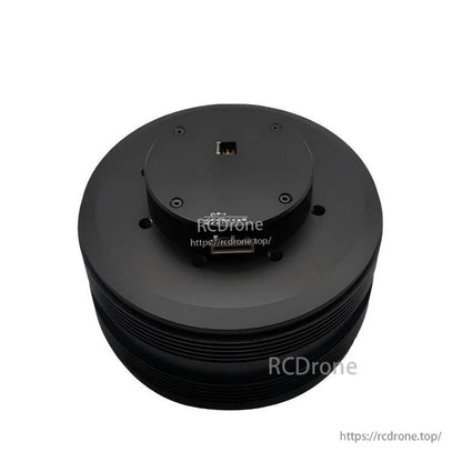Top view of round black servo motor housing with connector openings and mounting holes (watermarked image)