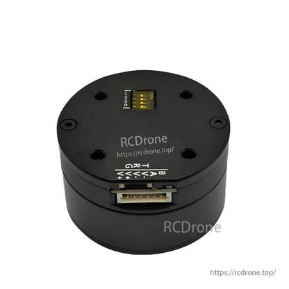 Top view showing DIP address switch and multi-pin control connector on round servo motor housing