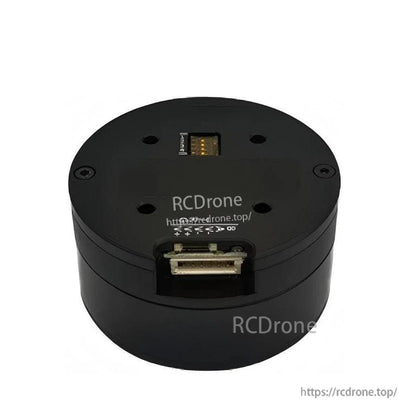 Top-side view of round servo motor housing with recessed connector port and mounting holes