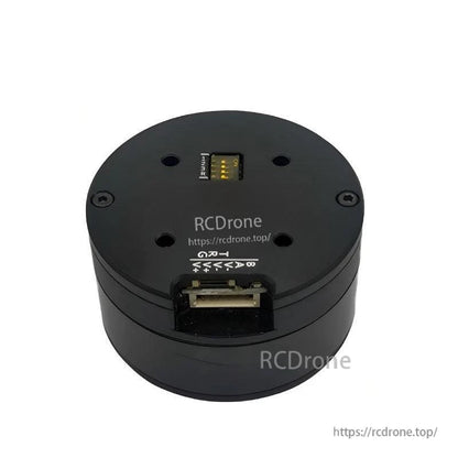 Top view of round servo motor showing wiring connector slot and pin label markings
