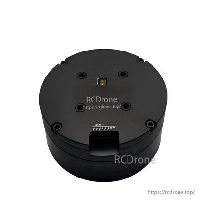 Top view of round servo motor housing with mounting holes and small connector port, RCDRone watermark overlay