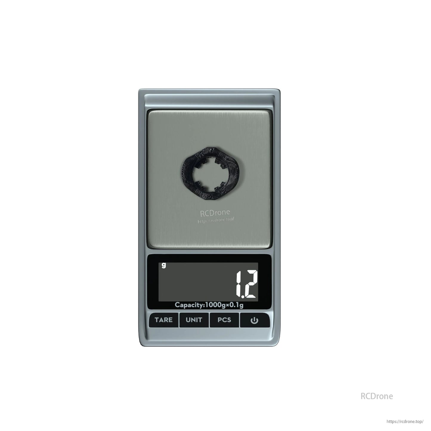 Small black circular ring part on a digital pocket scale reading 1.2 g