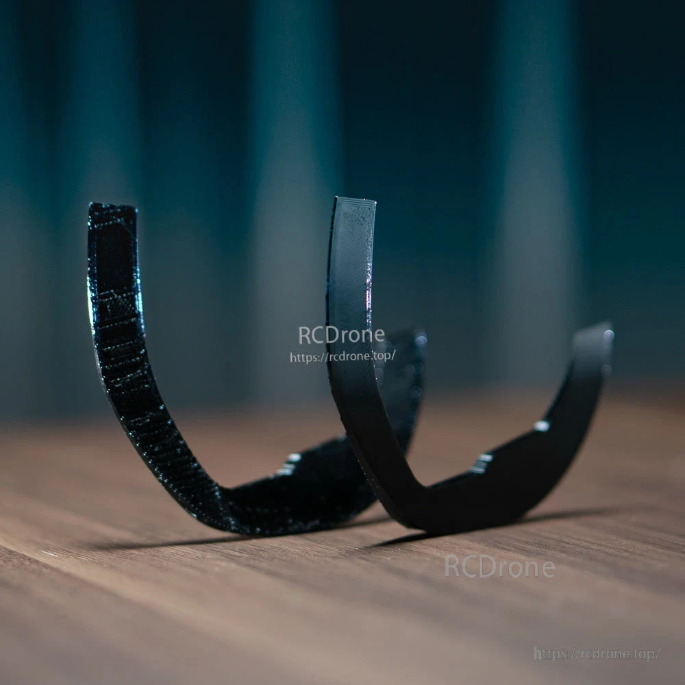 Side profile of 3D-printed goggle shim wedges standing upright, showing curved edge and height