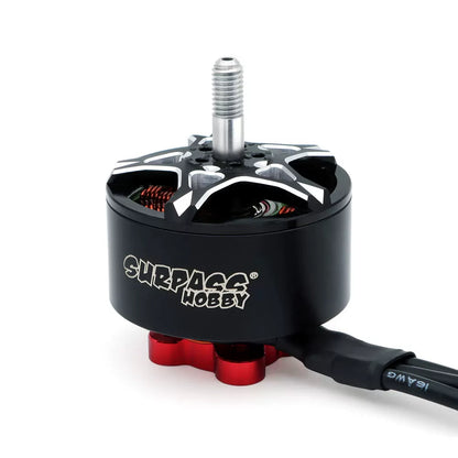 Close-up of black Surpass Hobby brushless motor with silver threaded shaft and red mounting base