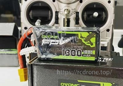 OVONIC 22.2V 6S 1300mAh 100C LiPo Battery on RC transmitter bench, FPV series label visible