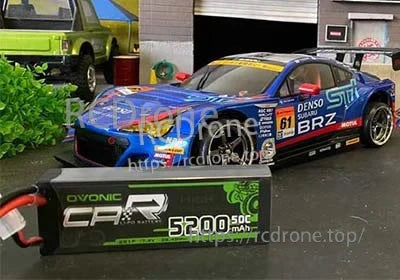 OVONIC 2S 5200mAh 50C 7.4V hardcase LiPo battery placed in front of a 1/10 RC touring car