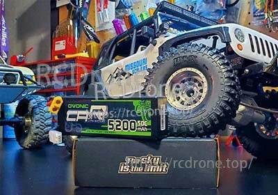 Ovonic hardcase 2S 7.4V 5200mAh LiPo with Deans connector beside an RC rock crawler truck