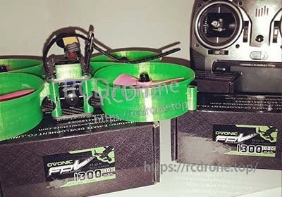 Ovonic 4S 1300mAh 80C LiPo battery displayed with FPV drone, green prop guards, and RC transmitter