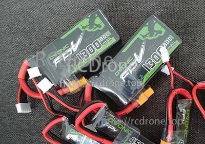 Close-up of Ovonic FPV 1300mAh 4S 80C LiPo packs with XT60 discharge plug and balance connector leads
