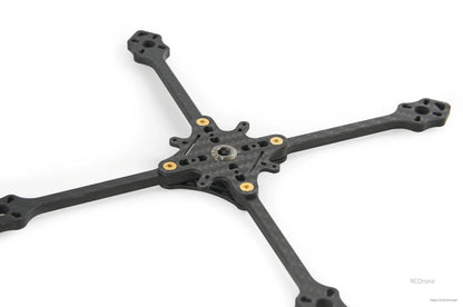 Low-angle view of carbon fiber toothpick frame base showing motor mount ends and center plate cutouts