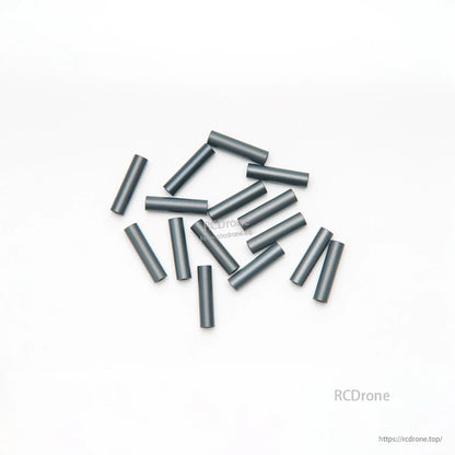 Unbranded black aluminum spacer tubes laid out on white background, multiple lengths