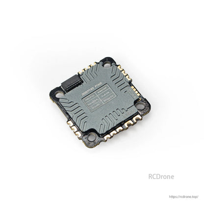 Angled rear view showing printed specification label and corner mounting holes on the AIO board