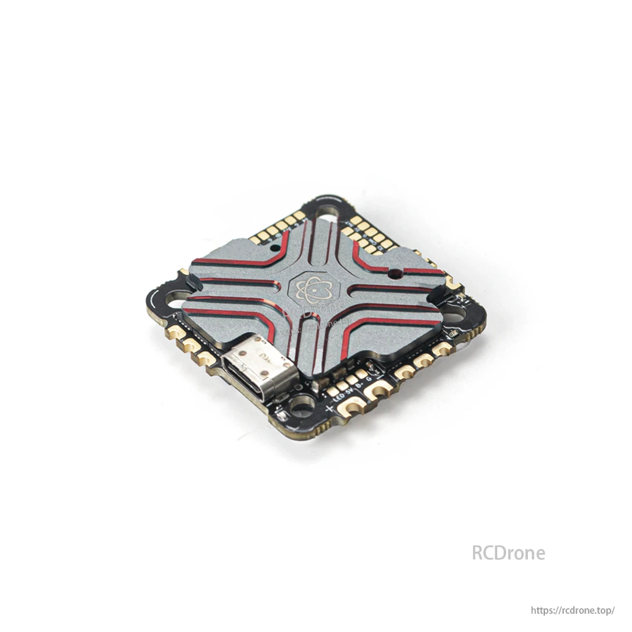 Angled top view of the AIO flight controller heatsink cover with USB-C connector and solder pads
