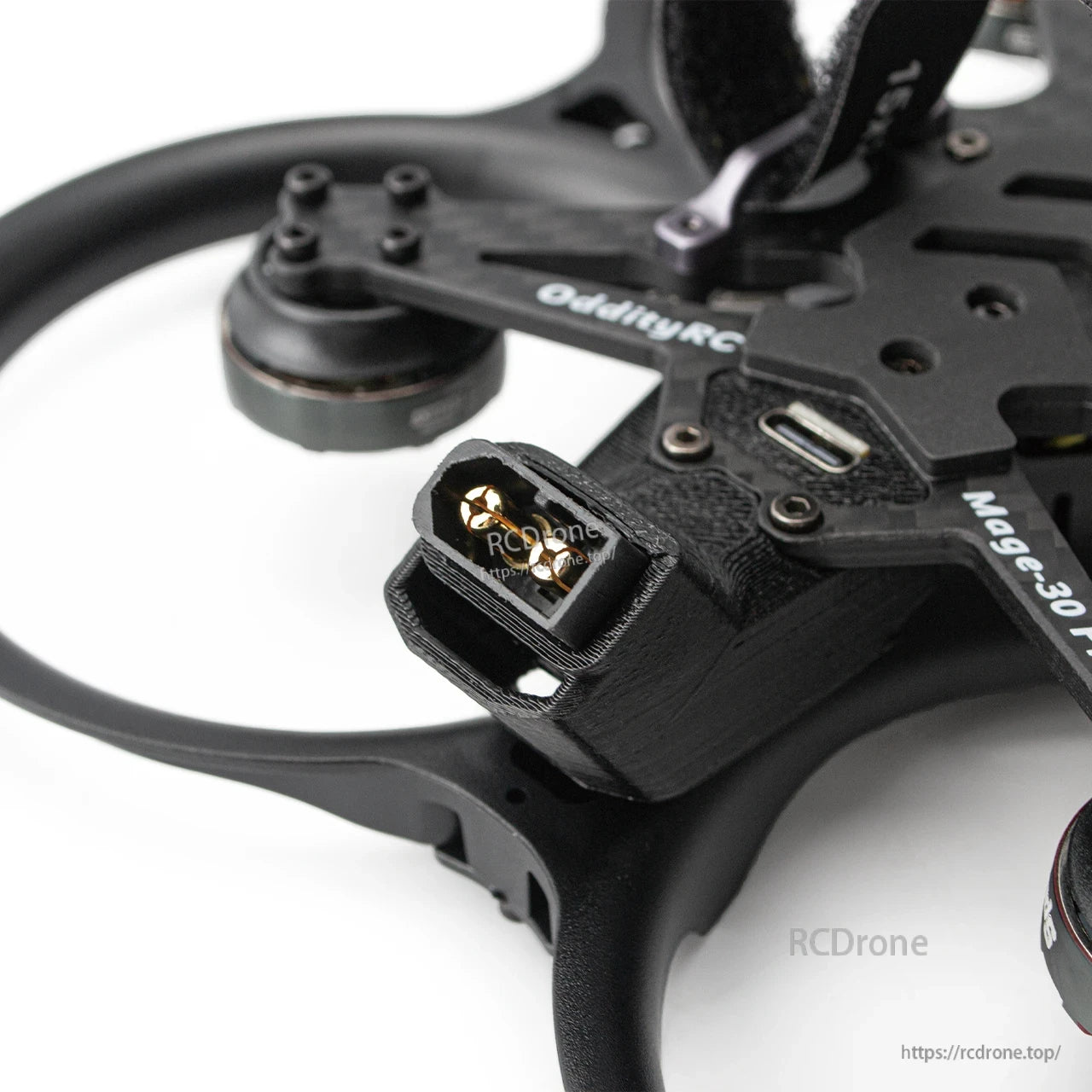 Close-up of battery connector plug on the frame with nearby USB port on top plate