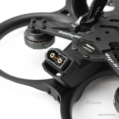 Close-up of battery connector plug on the frame with nearby USB port on top plate