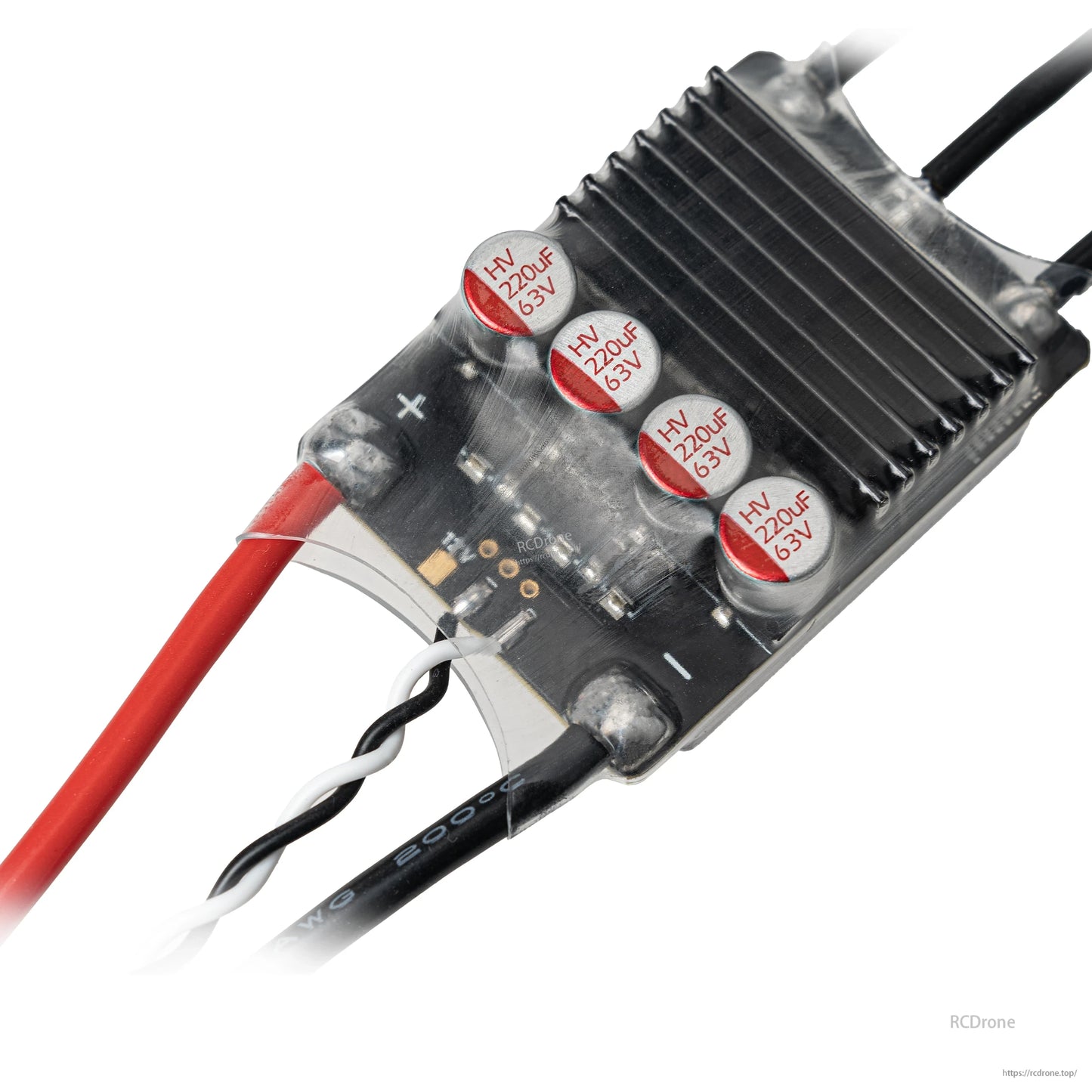 Close-up of ESC capacitors and heatsink area with plus and minus markings near the power input
