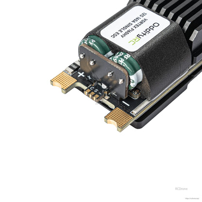 Close-up of ESC power pad area with plus/minus markings and soldered terminal plate