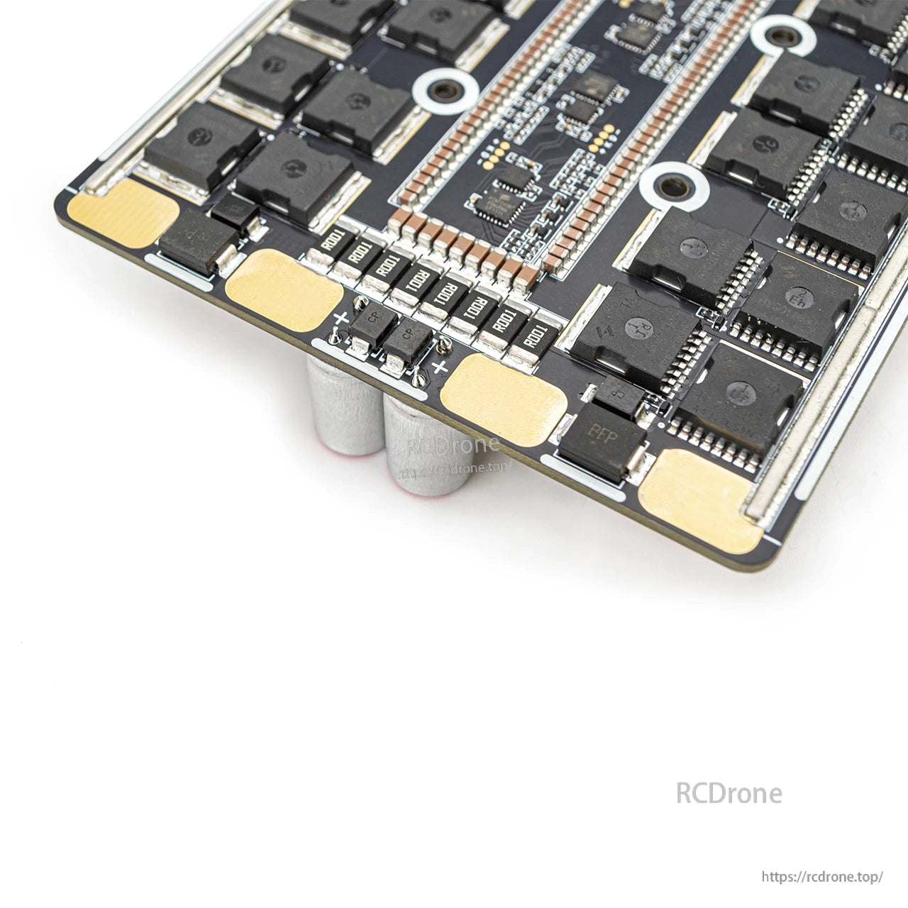 Close-up of ESC underside corner showing large solder pads and small components near board edge