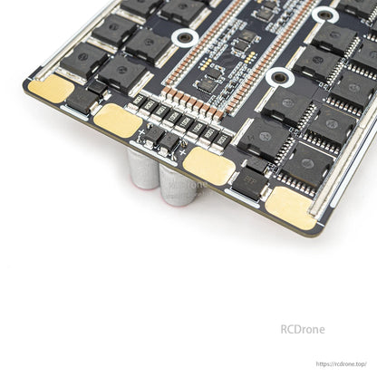 Close-up of ESC underside corner showing large solder pads and small components near board edge