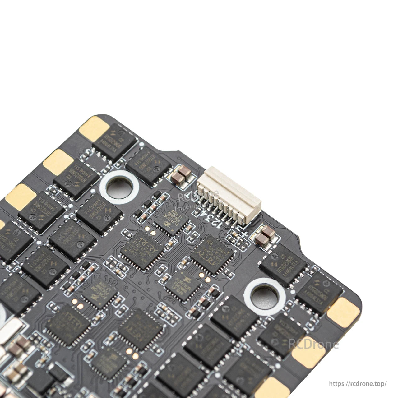 Close-up of ESC signal connector and control chips, showing JST socket and mounting hole