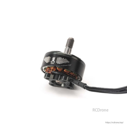 Side view of motor can with logo and solder pads, showing copper windings and attached power lead wires