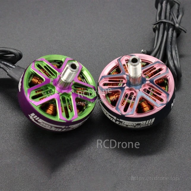 Two brushless motors side by side on black background, green and pink rotor color options