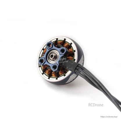 Bottom view showing mounting screw holes, bearing, stator windings, and attached motor wires