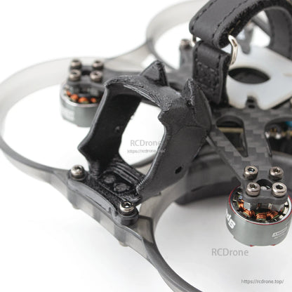 Close-up of front camera mount and carbon frame hardware with duct ring and exposed motor windings