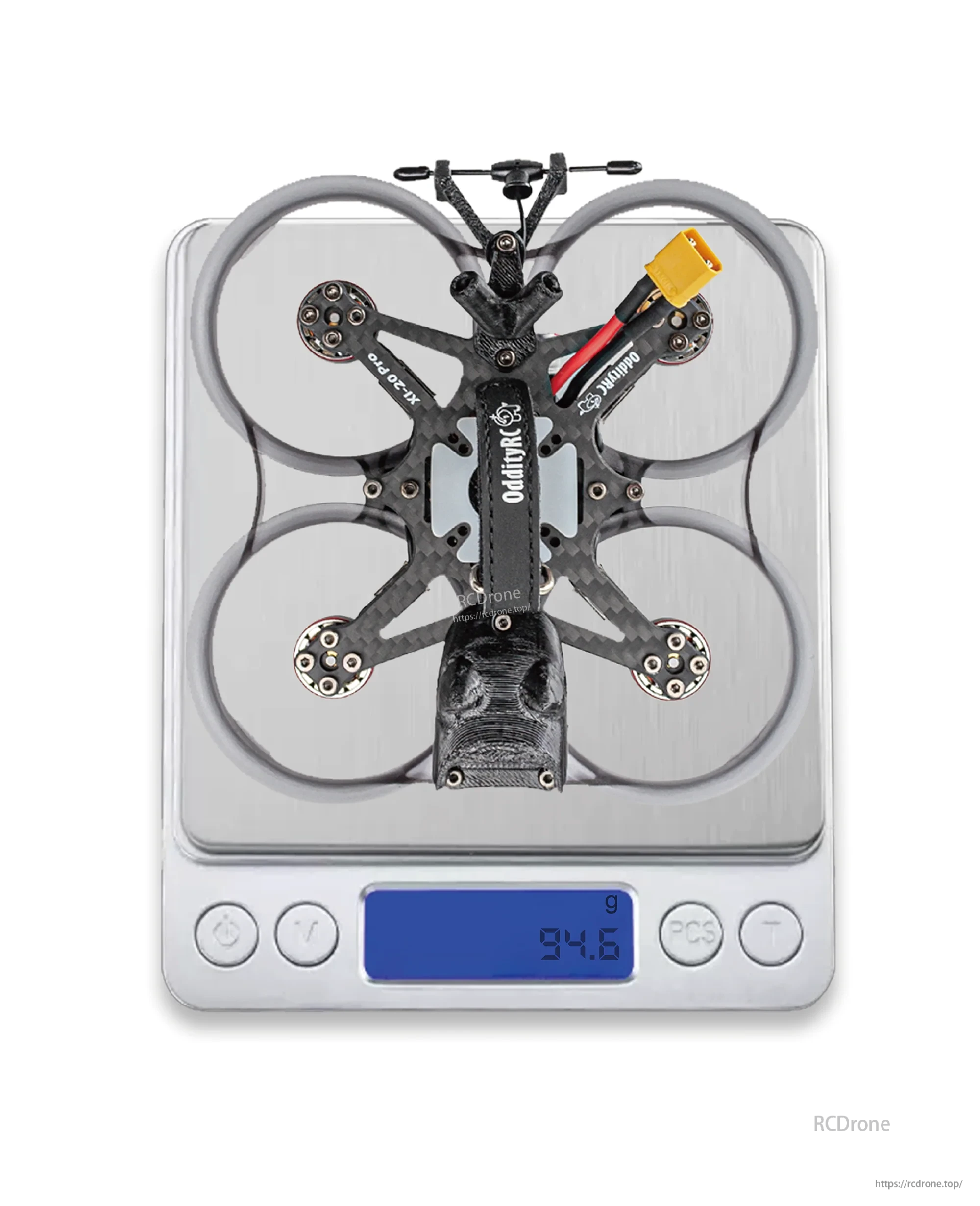 Drone on a digital scale showing 94.6 g weight with ducts and XT30 cable installed