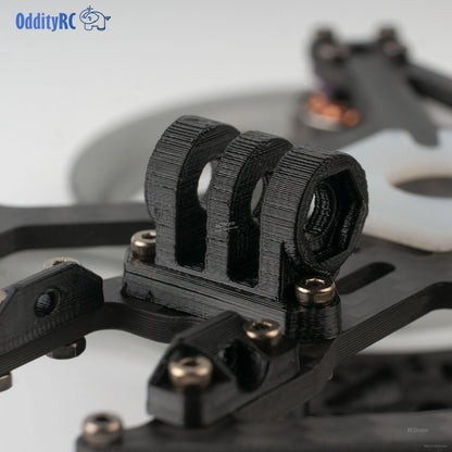 Close-up of 3D-printed camera cage/canopy mount on the frame plate